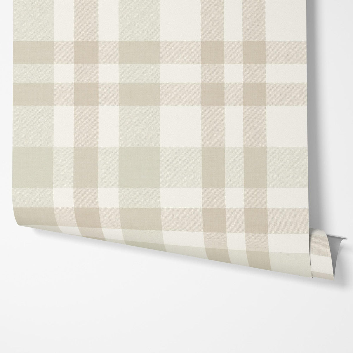 A panel of beige and cream Hollis plaid wallpaper being hung on a wall