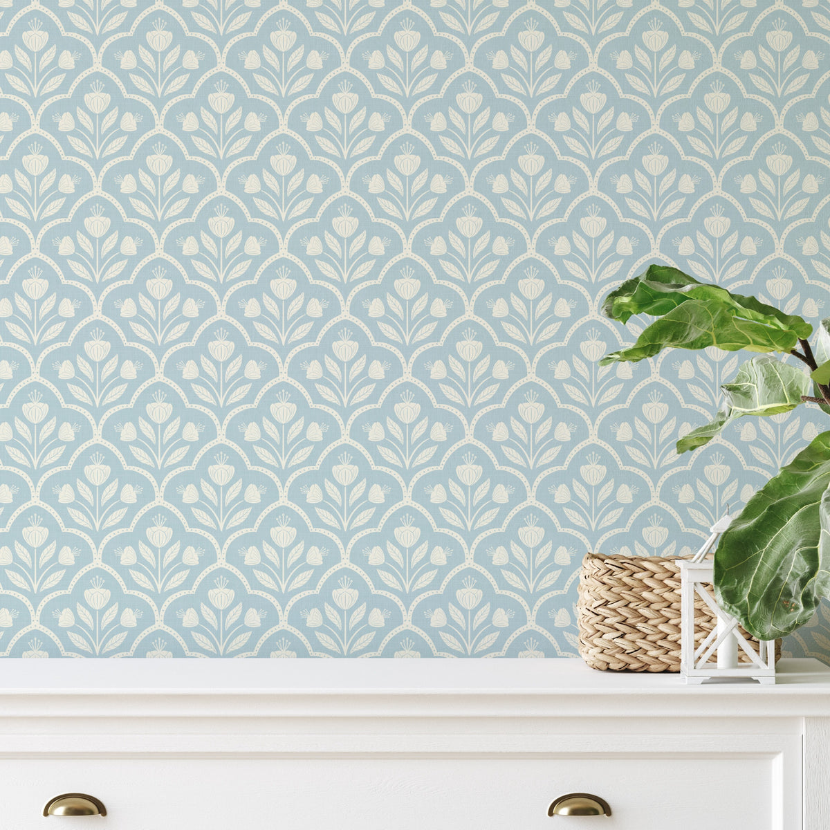 blue wallpaper with vintage floral tulips in removable peel and stick, prepasted or traditional nonpasted wallpaper samples and rolls. Shown on a wall in a coastal or cottagecore inspired space.