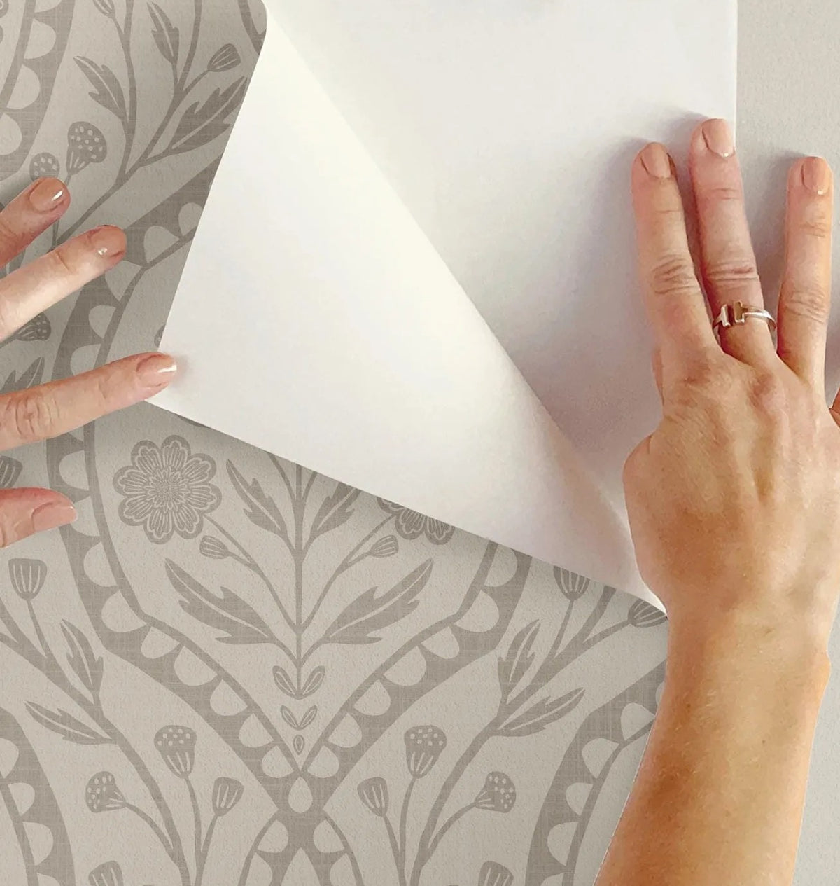 wallpaper shown in peel and stick or removable prepasted. neutral beige and off white French country wallpaper with elegant wildflower damask. Renter-friendly subtle botanical design for a timeless baby girl nursery, bedroom, or bathroom wall.