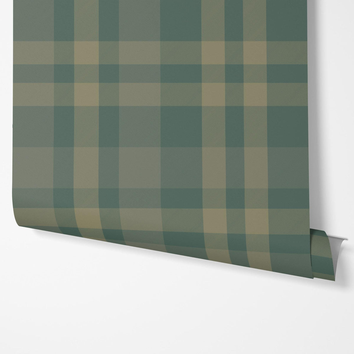 Panel of dark green plaid peel and stick wallpaper hung on a wall