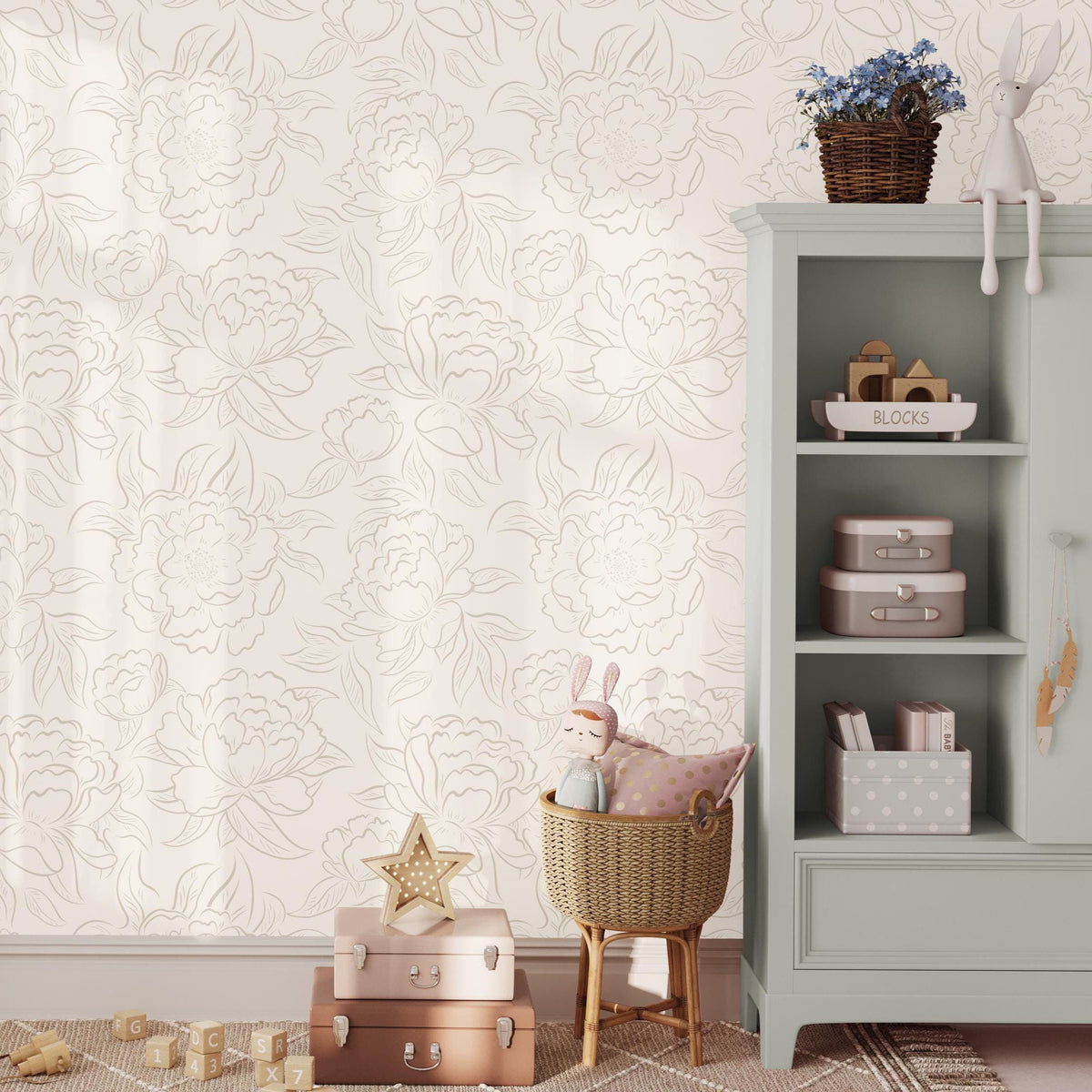 Kids' room with a sage green cabinet and toys against neutral Peony Sketch floral wallpaper