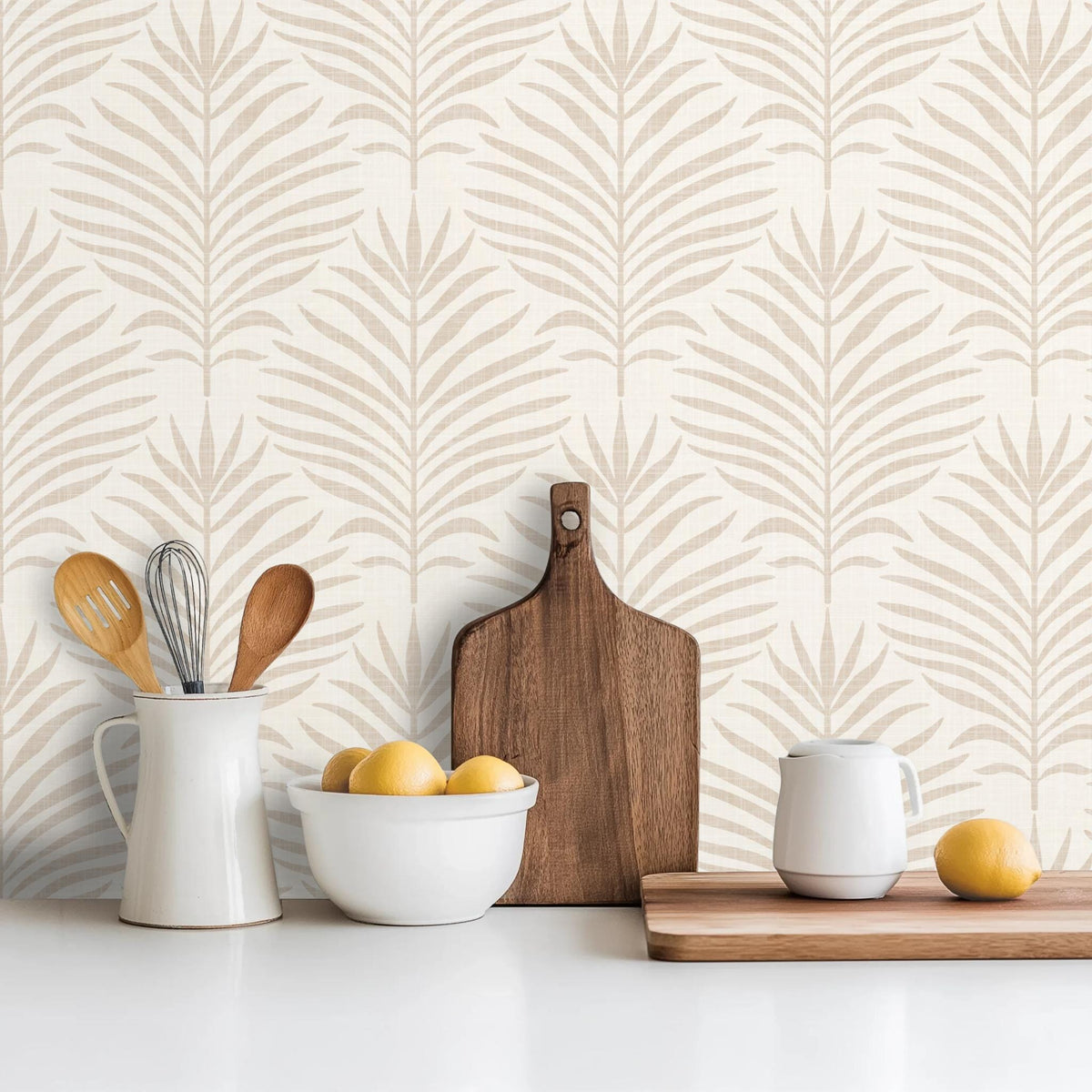 Kitchen counter in front of a wall of beige and white Palm Breeze palm leaf wallpaper