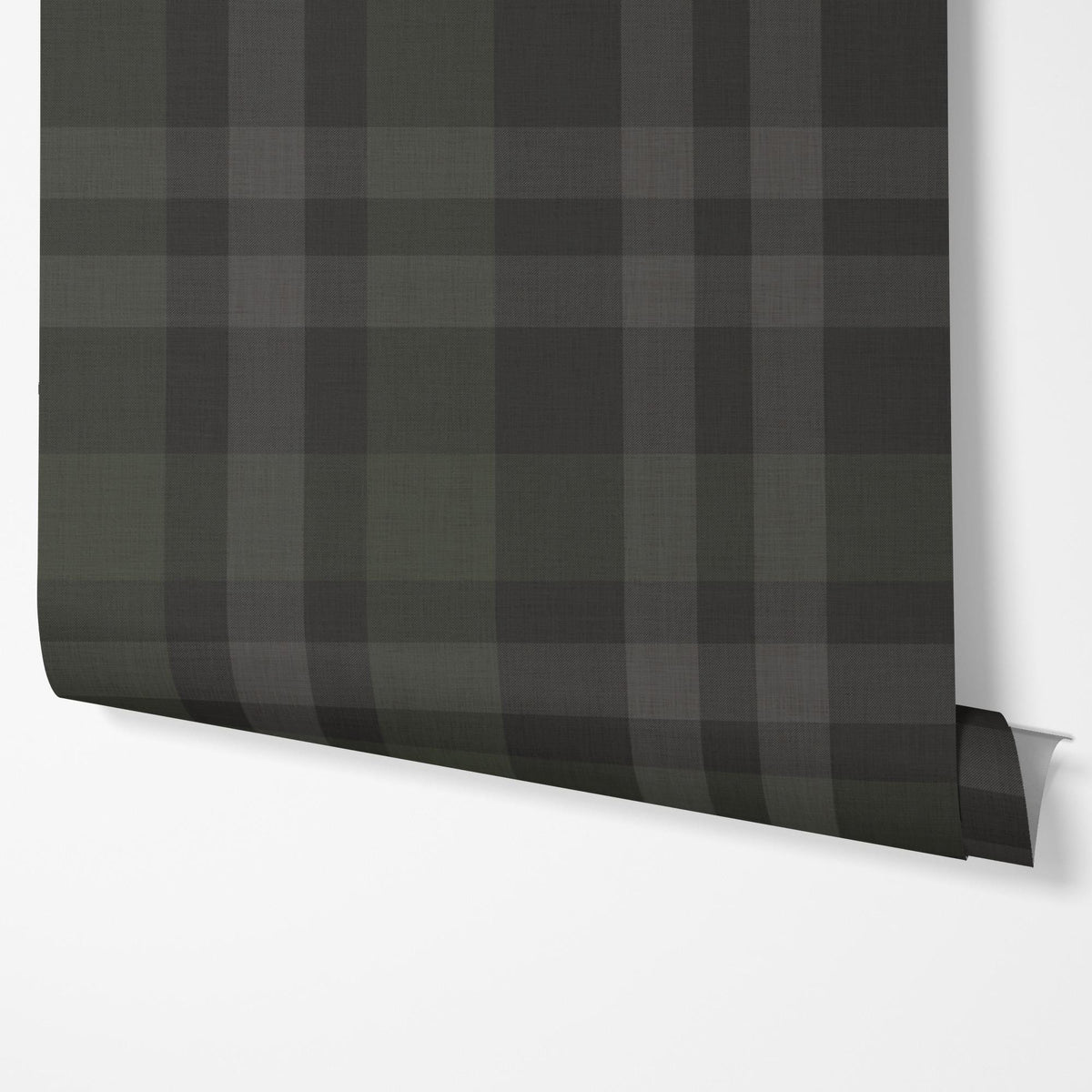 Panel of black plaid peel and stick wallpaper hung on a wall
