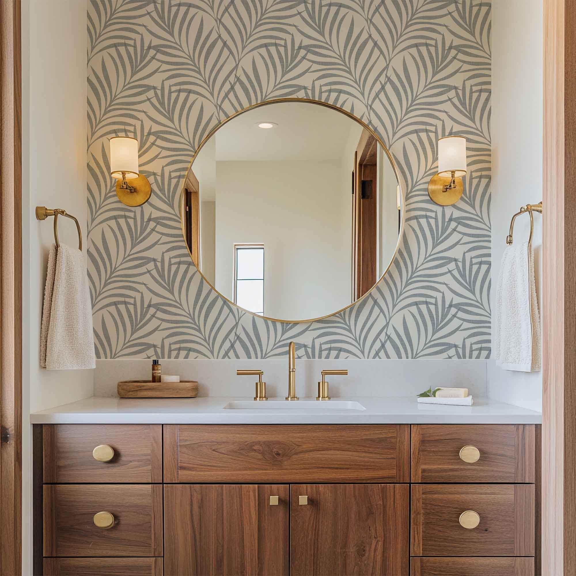 blue and off white palm leaf removable wallpaper available in peel and stick with a faux linen texture for japandi, coastal, and boho decor styles. featured on bathroom accent wall.
