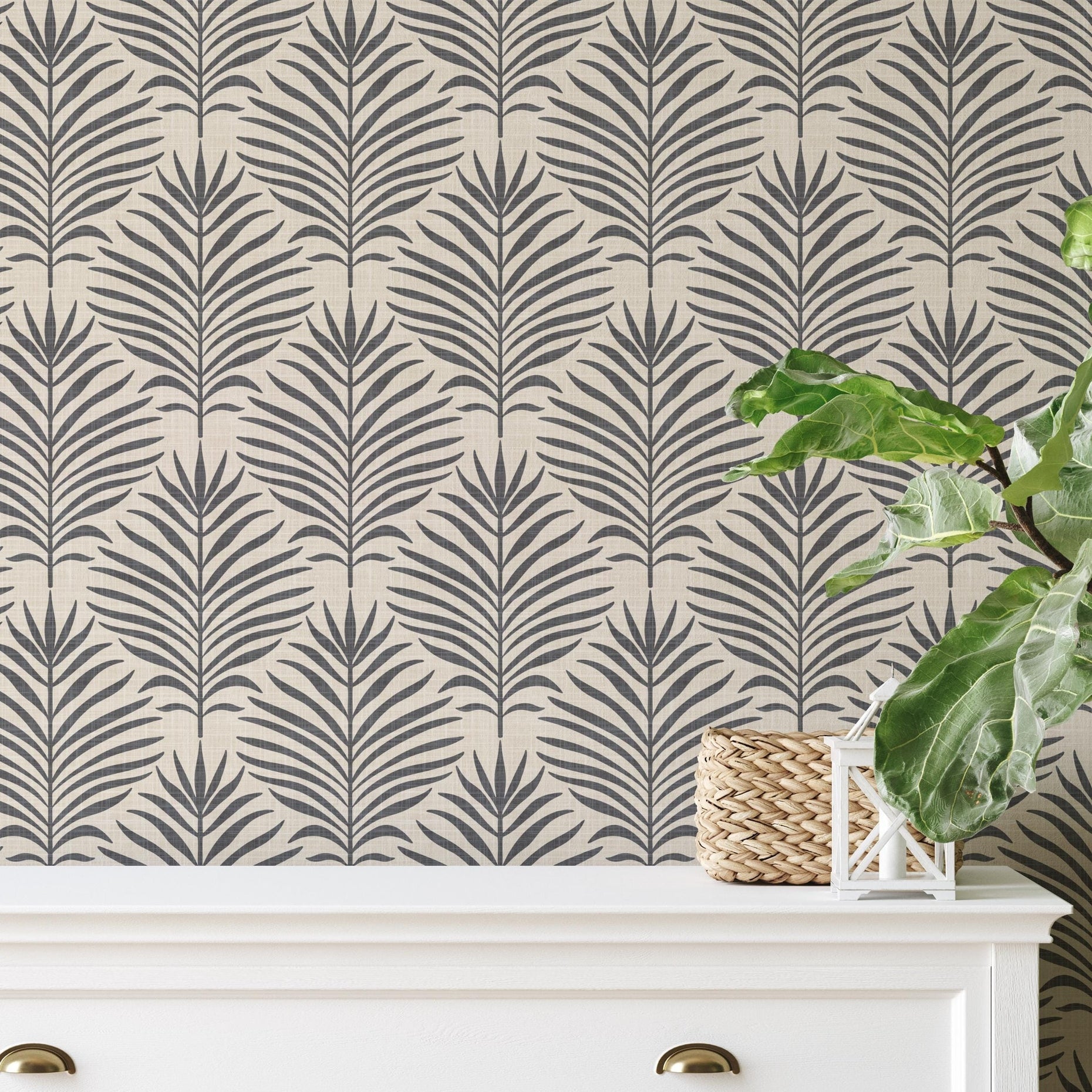Neutral black and tan palm leaf wallpaper available in peel and stick and prepasted in a modern tropical boho style with a subtle linen texture, ideal for coastal bedrooms, powder rooms, or Japandi accent walls. featured in living room statement wall behind dresser.