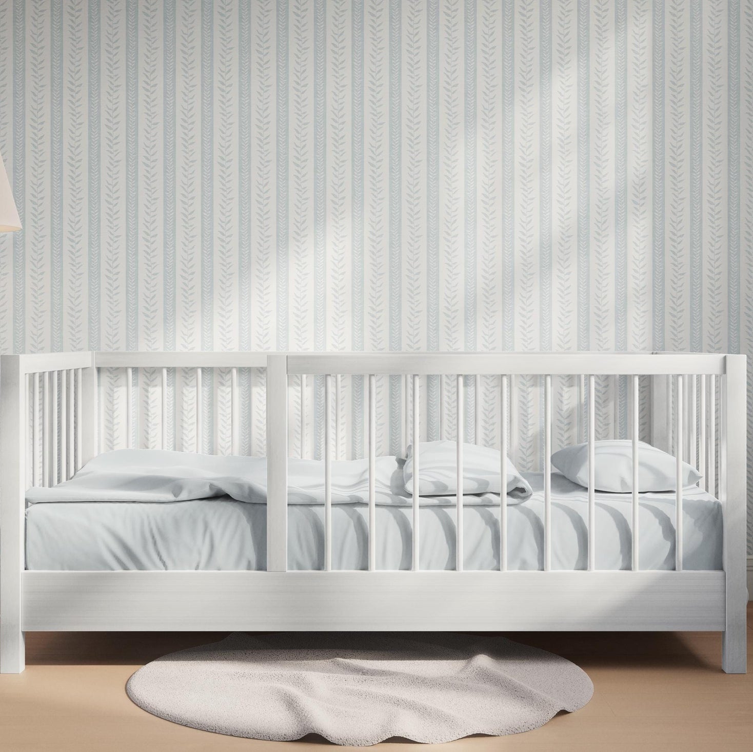 modern coastal wallpaper with tropical botanical stripe in light blue and white for baby boy nursery, bedroom, bathroom accent wall, or calming beach home inspired spaces. Shown in peel and stick or prepasted removable renter friendly wallpaper.