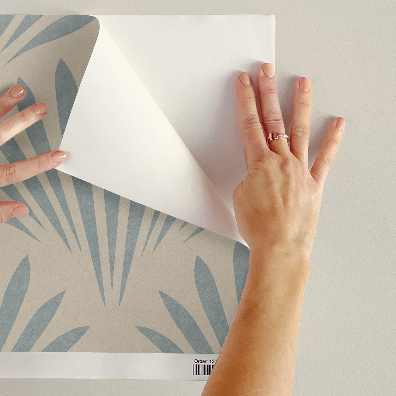 light blue mediterranean scallop wallpaper resembling floral or seashell. Art Deco inspired and fitting into a modern coastal interior. Shown in removable renter friendly peel and stick or prepasted, perfect for coastal bathrooms, bedrooms, or accent walls in mid century modern interiors