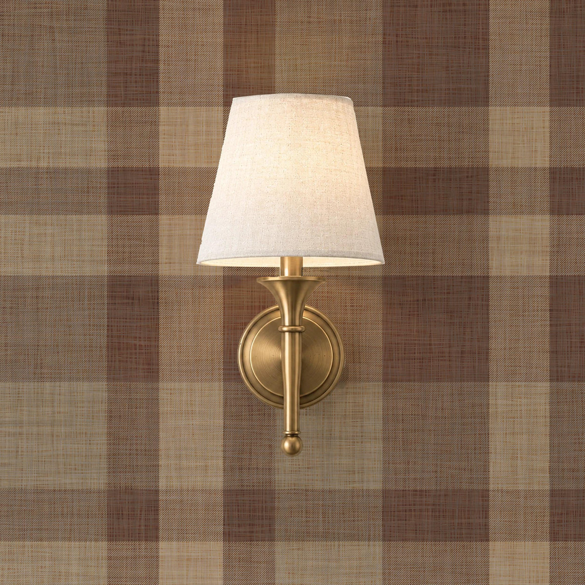 Brown plaid wallpaper with a brass sconce in a ski lodge style room