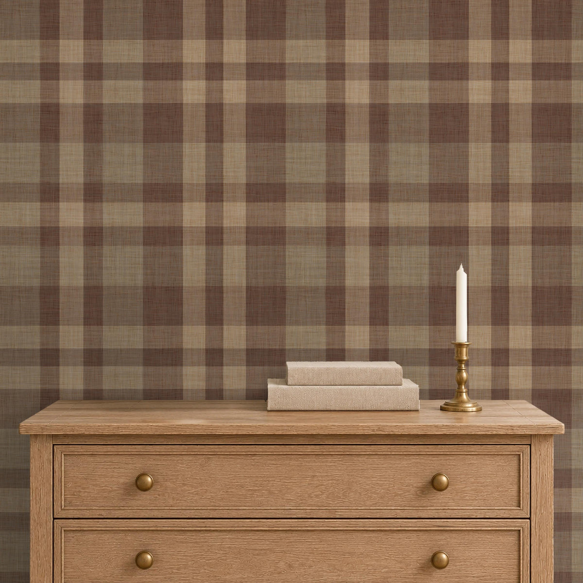 Wooden dresser with books and a candle against Hollis Plaid wallpaper in brown and tan