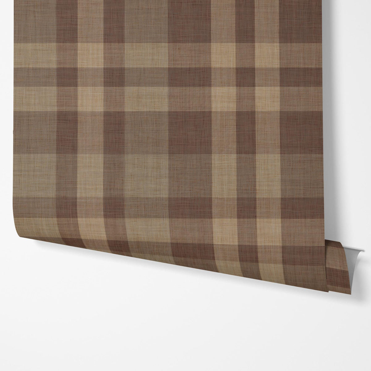 Panel of brown plaid peel and stick wallpaper hung on a wall