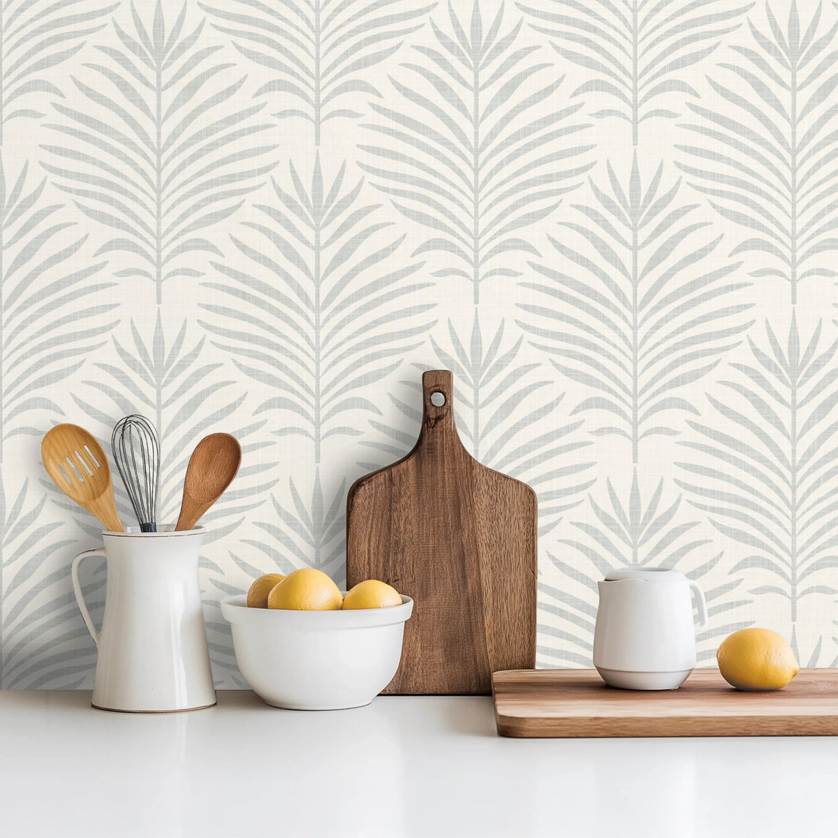 coastal botanical palm leaf wallpaper in gray and white for modern beach house or tropical decor in peel and stick, prepasted, or traditional nonpasted samples and rolls or panels