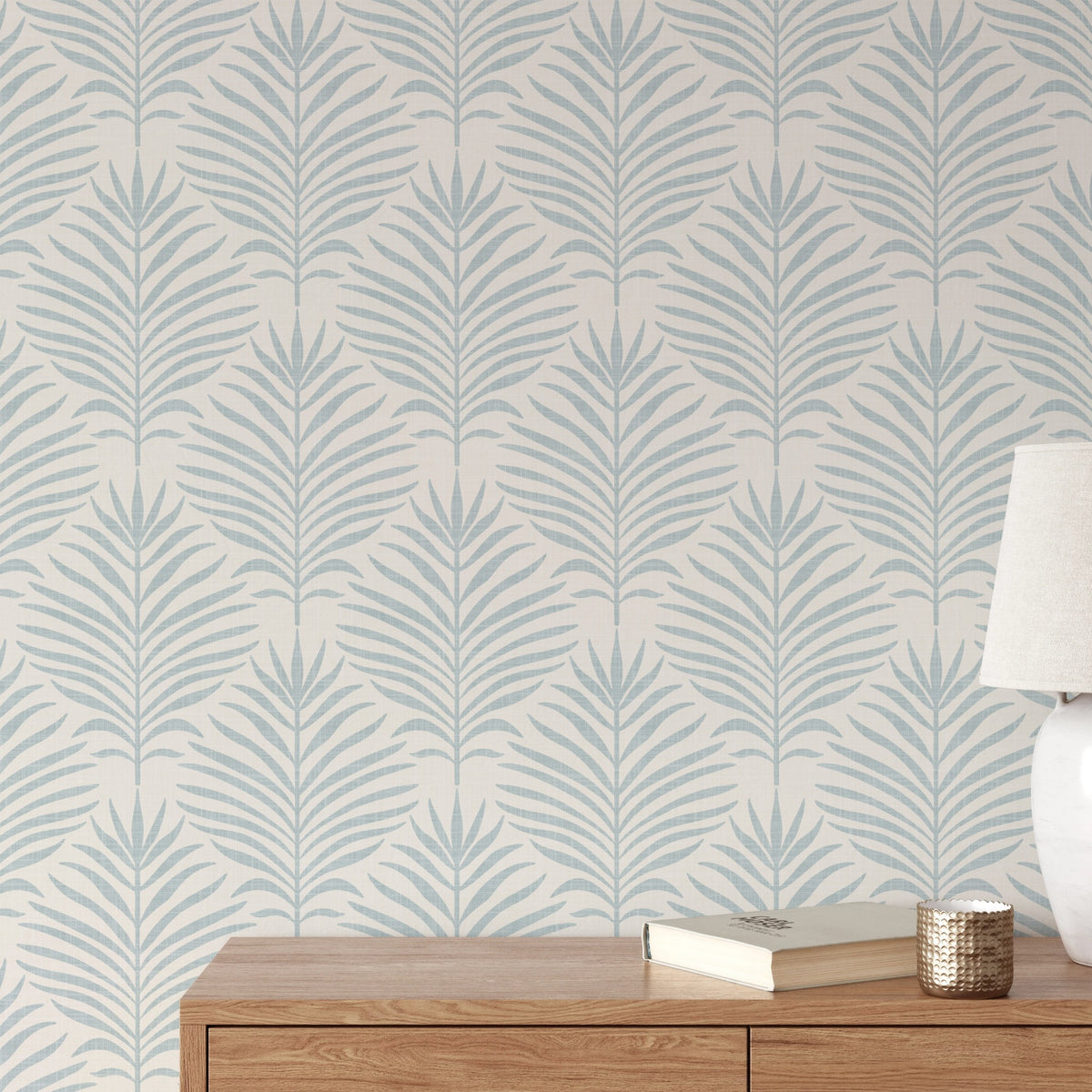coastal palm leaf botanical wallpaper in light blue and white for modern beach house or tropical decor in peel and stick, prepasted, or traditional nonpasted samples and rolls or panels