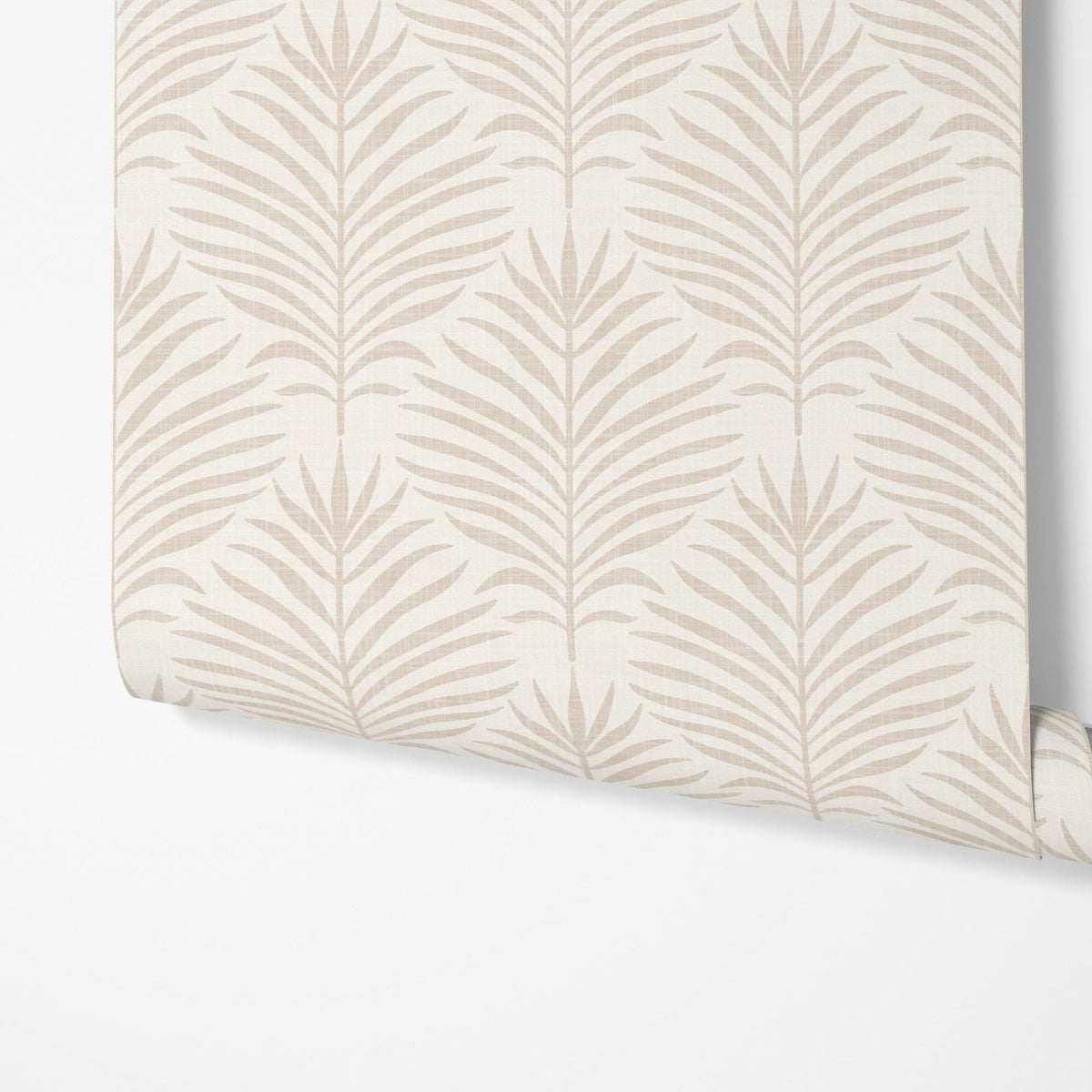 A panel of beige and white Palm Breeze palm leaf wallpaper being hung on a wall