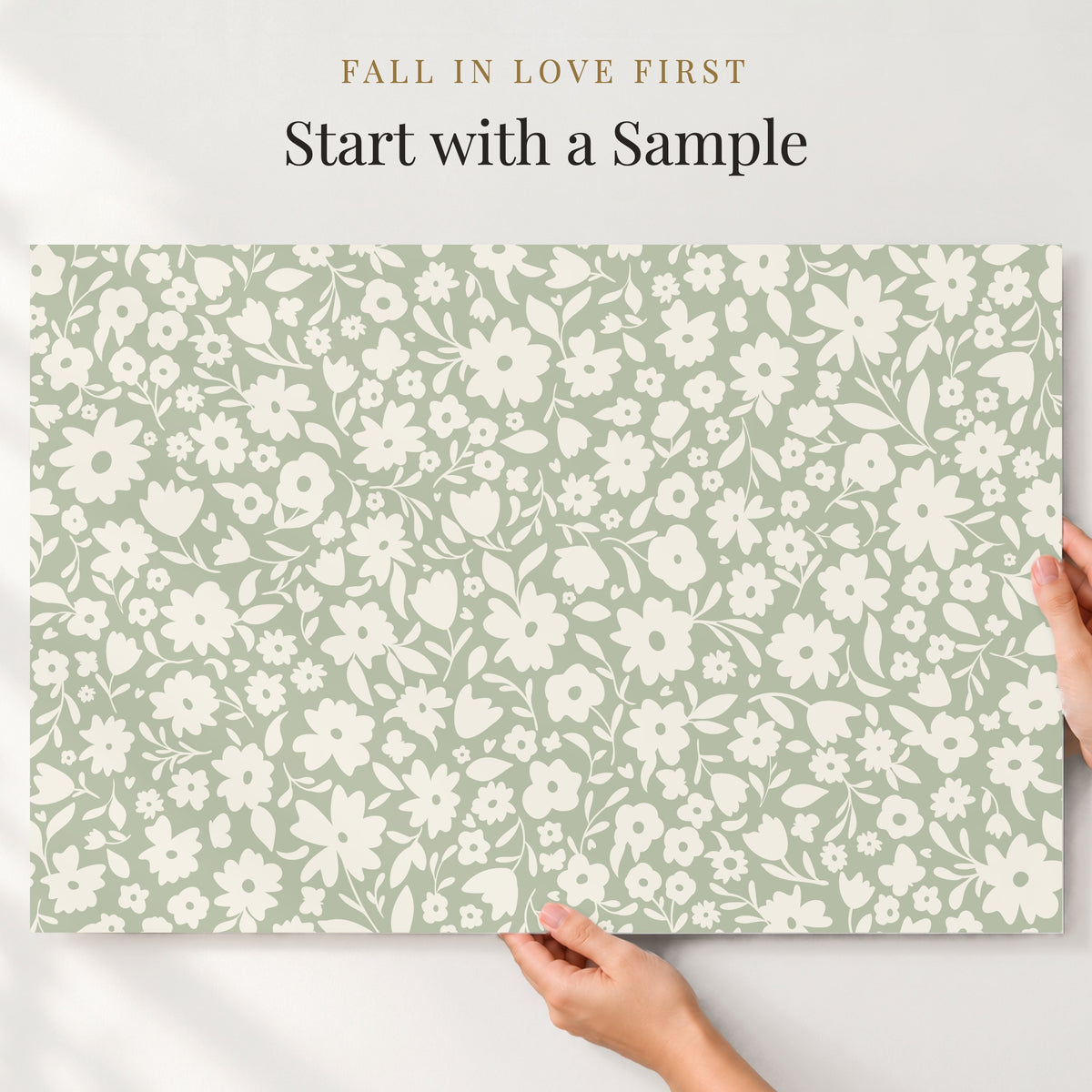 A hand is holding a piece of paper with a floral pattern on it, and there is text above the paper that reads "Fall in love first. Start with a sample".