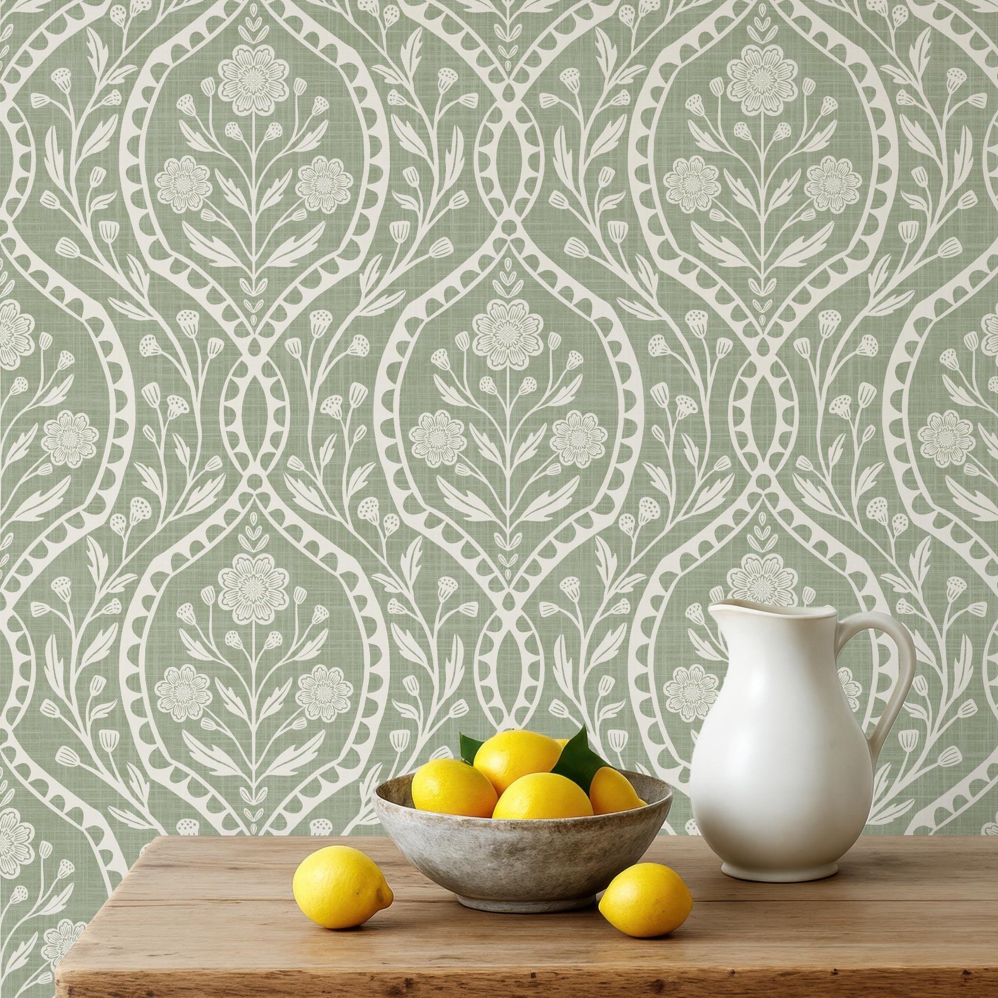 Sage green and white floral wallpaper with a wildflower floral damask pattern. Shown in peel and stick or prepasted for a removable renter friendly option for traditional or french country aesthetic suitable for baby nursery, bedroom, bathroom, kitchen or dining room.