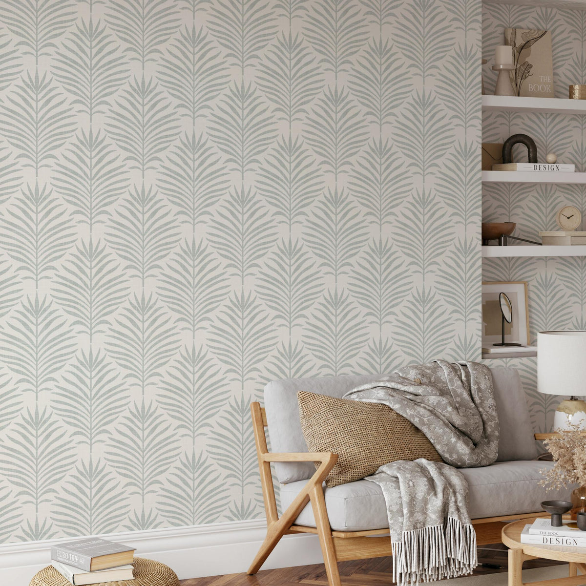 Living room with a sofa and shelves against gray green and white Palm Breeze palm leaf wallpaper