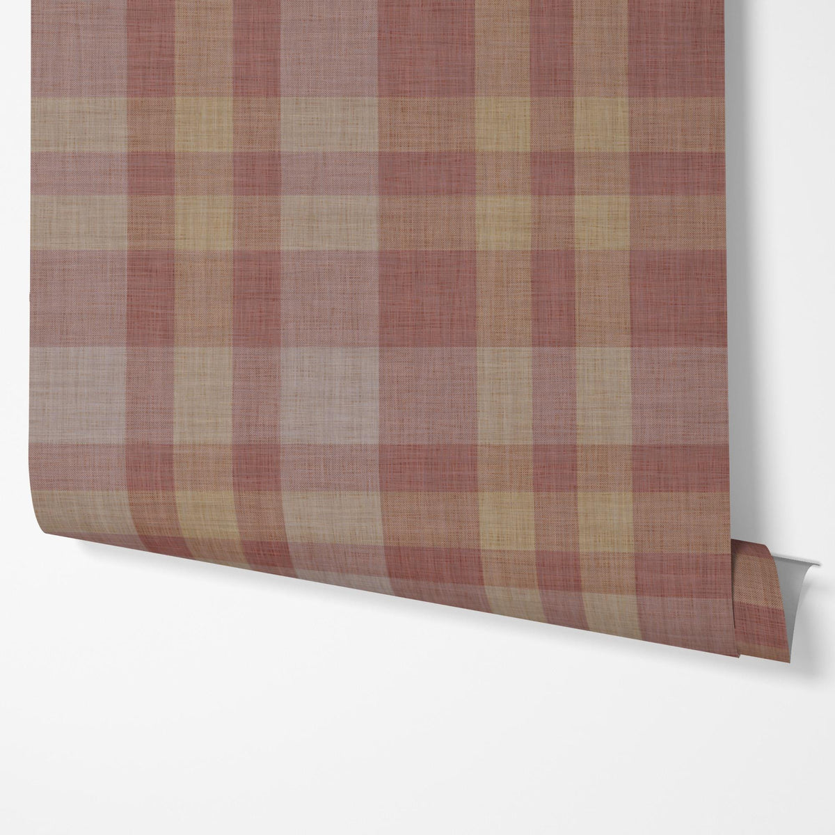 Panel of burgundy plaid peel and stick wallpaper hung on a wall