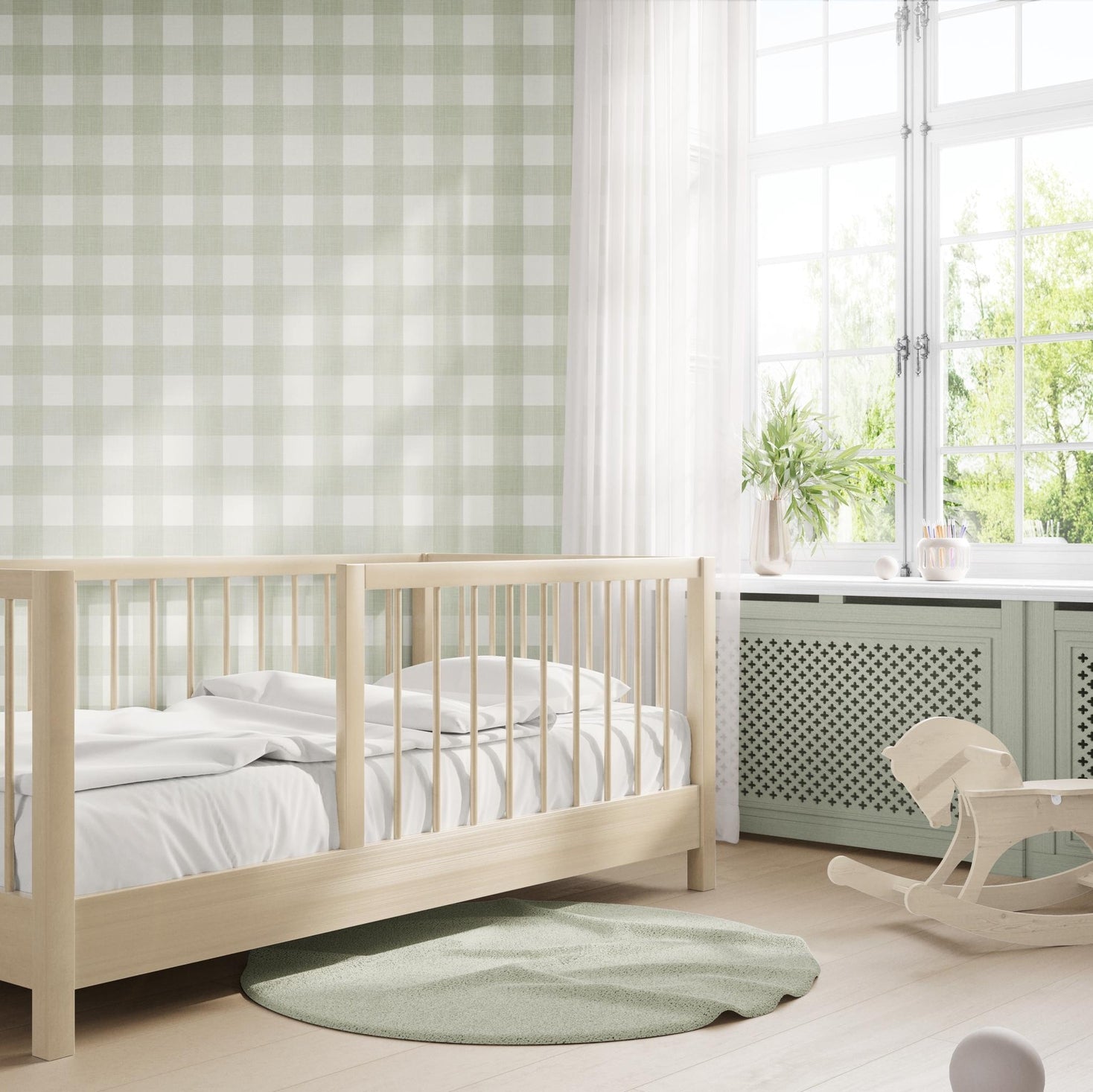 light sage olive green gingham removable wallpaper with a linen look texture and roughly 3" squares featured on nursery accent wall behind toddler bed in gender neutral childrens room.