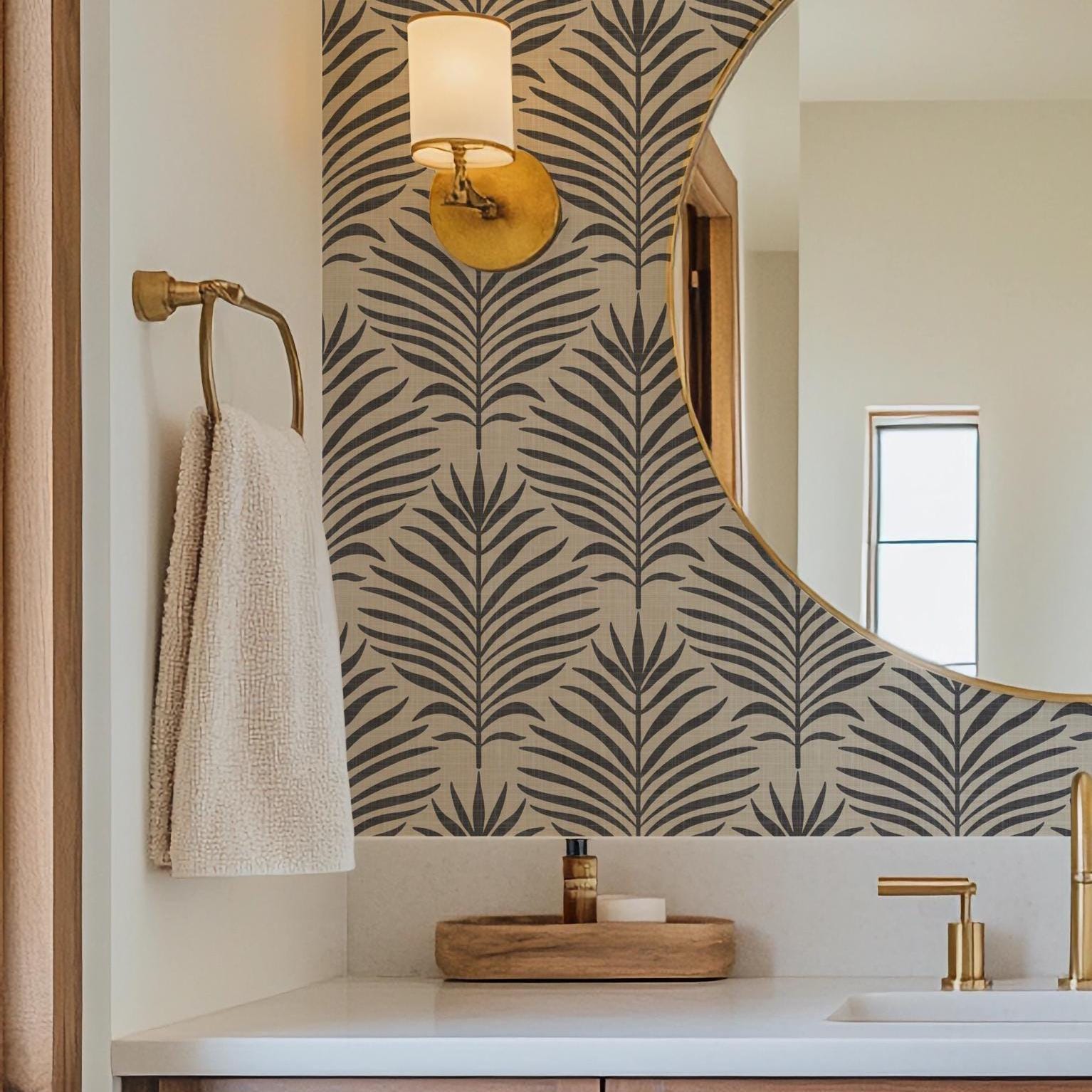Neutral black and tan palm leaf wallpaper available in peel and stick and prepasted in a modern tropical boho style with a subtle linen texture, ideal for coastal bedrooms, powder rooms, or Japandi accent walls. featured as bathroom accent wall.