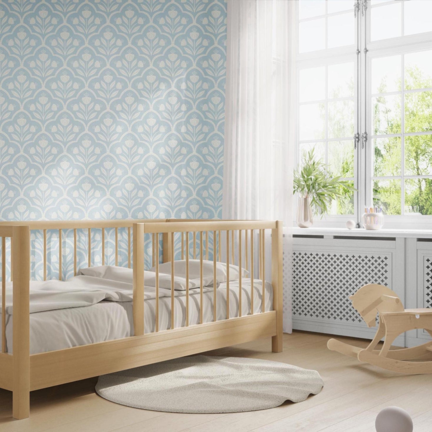 Wallpaper Removable in peel and stick or Pre-Pasted. A light blue pastel Cottagecore Wildflower Floral for Baby Nursery, Bathroom, Laundry Room Accent wall. Features a repeating medallion print with flowers inside for a vintage or tiled appearance. featured in baby nursery or toddler room.