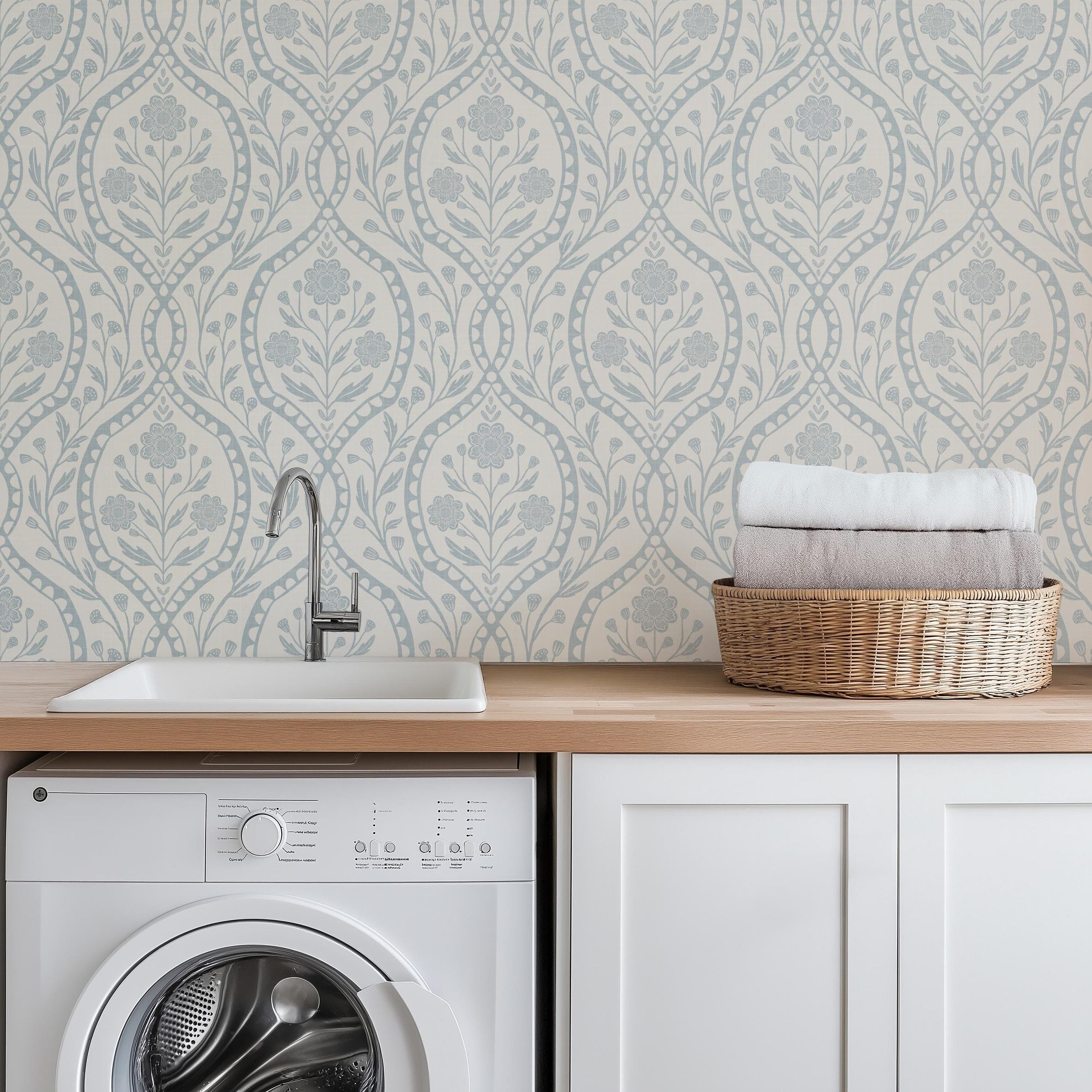 Light blue French country wallpaper with elegant wildflowers on an off-white background. Renter-friendly design for nursery, bedroom, or bathroom wall.
