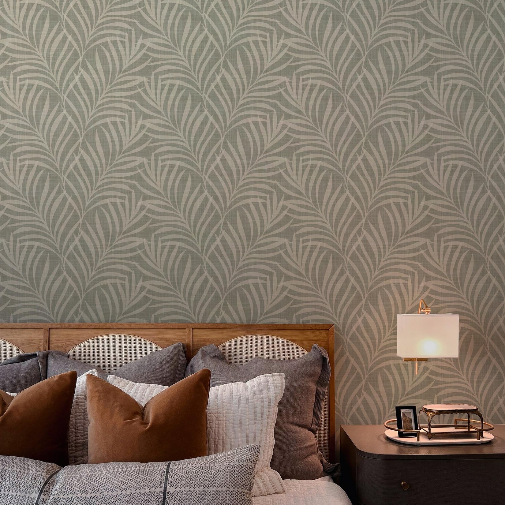Neutral olive green wallpaper available in peel and stick and prepasted in a modern tropical boho style with palm leaves and subtle linen texture, ideal for coastal bedrooms, powder rooms, or Japandi accent walls. featured as bathroom accent wall. featured as bedroom feature wall.