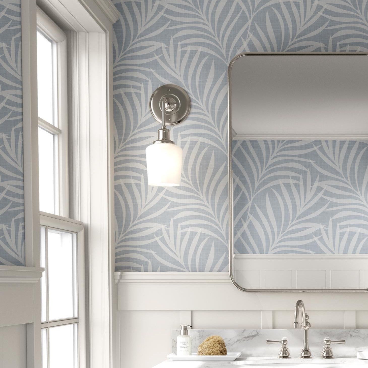 tropical boho palm leaf wallpaper in soft calm blue and white shown in removable peel and stick or prepasted. Perfect for modern coastal bathroom, powder room, nursery or laundry room accent wall.