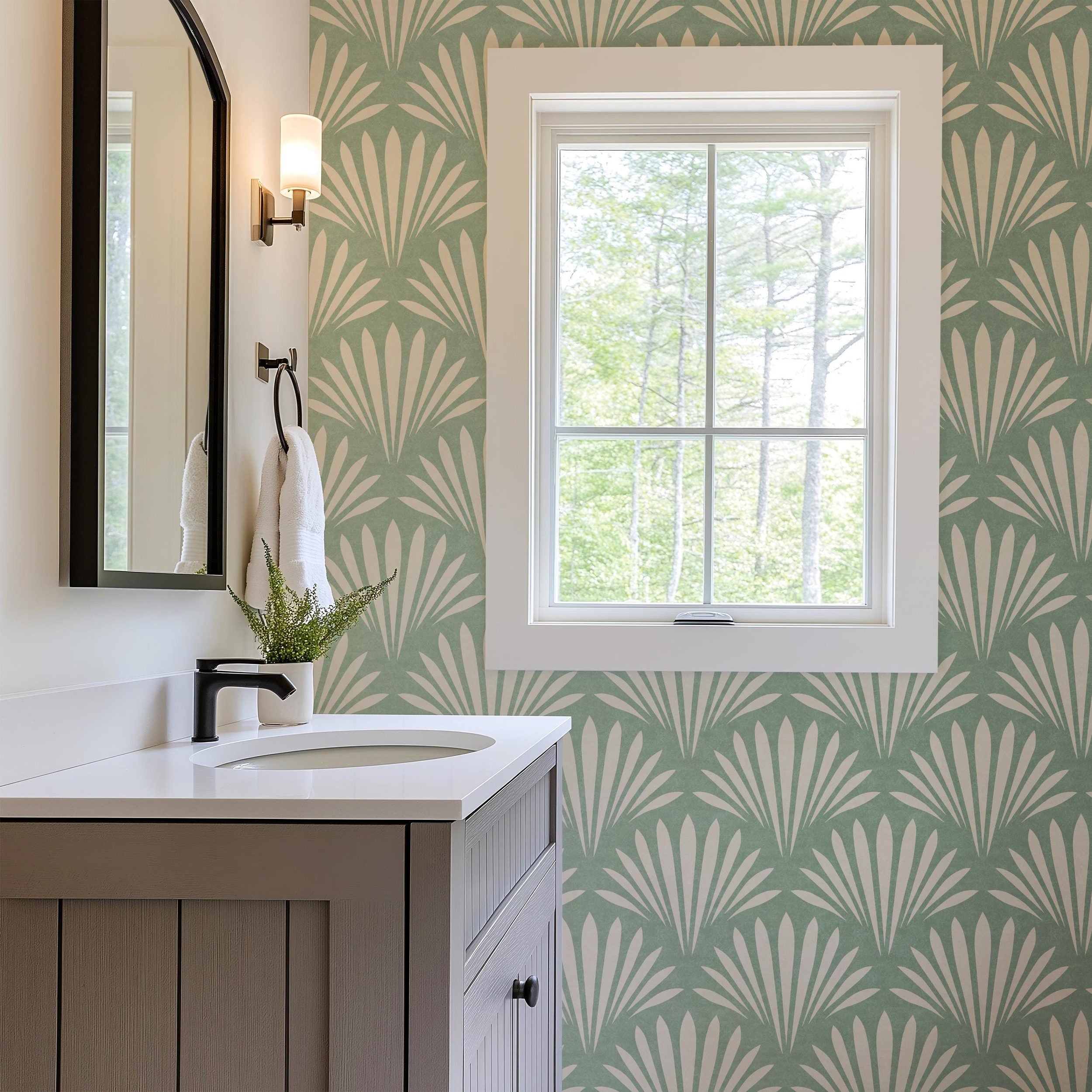 Wallpaper shown in peel and stick or removable pre-pasted in aqua green and off white with seashell palm fan print. A tropical boho modern coastal print for bathroom wallpaper, powder room, baby nursery, bedroom or accent wall.