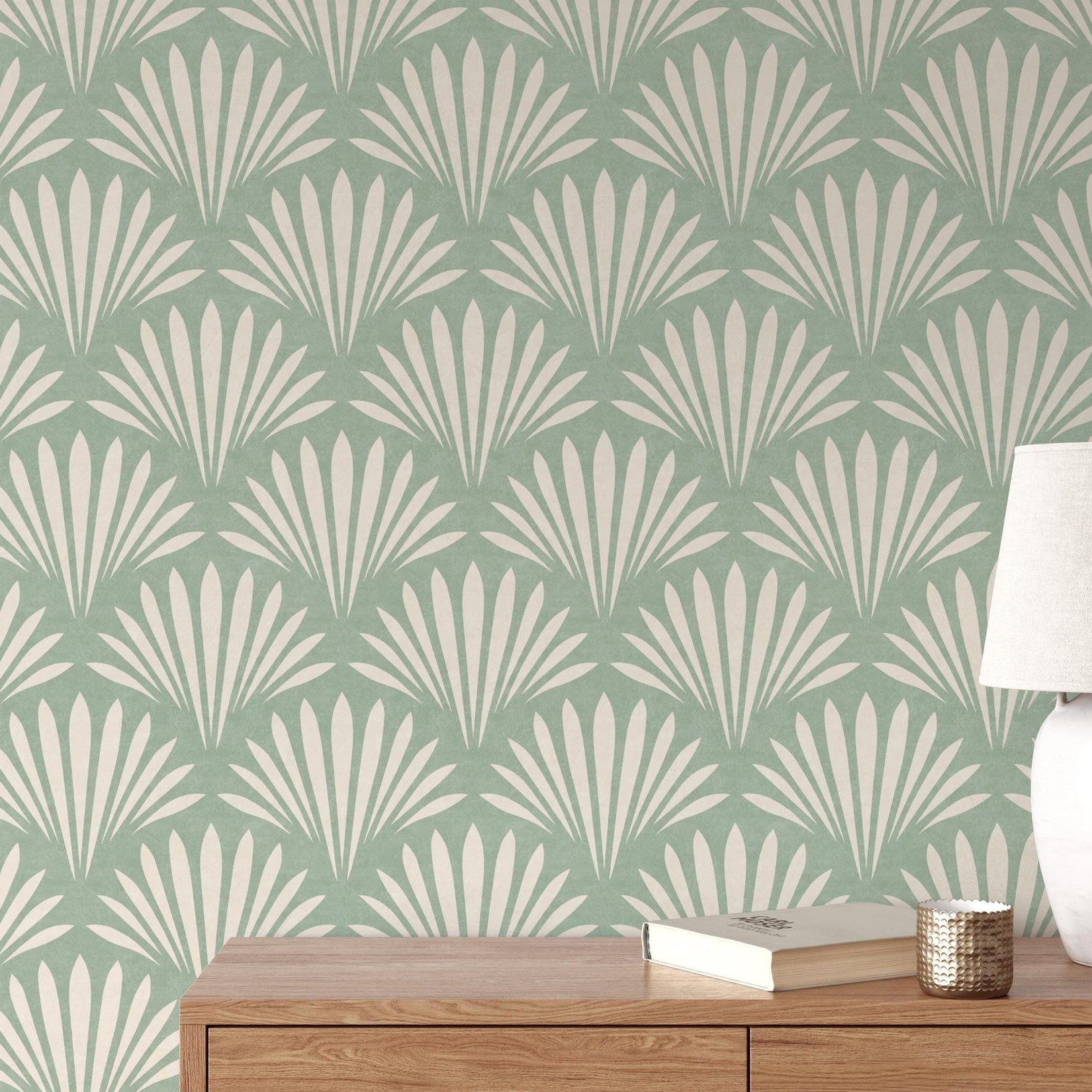Wallpaper shown in peel and stick or removable pre-pasted in aqua green and off white with seashell palm fan print. A tropical boho modern coastal print for bathroom wallpaper, powder room, baby nursery, bedroom or accent wall.