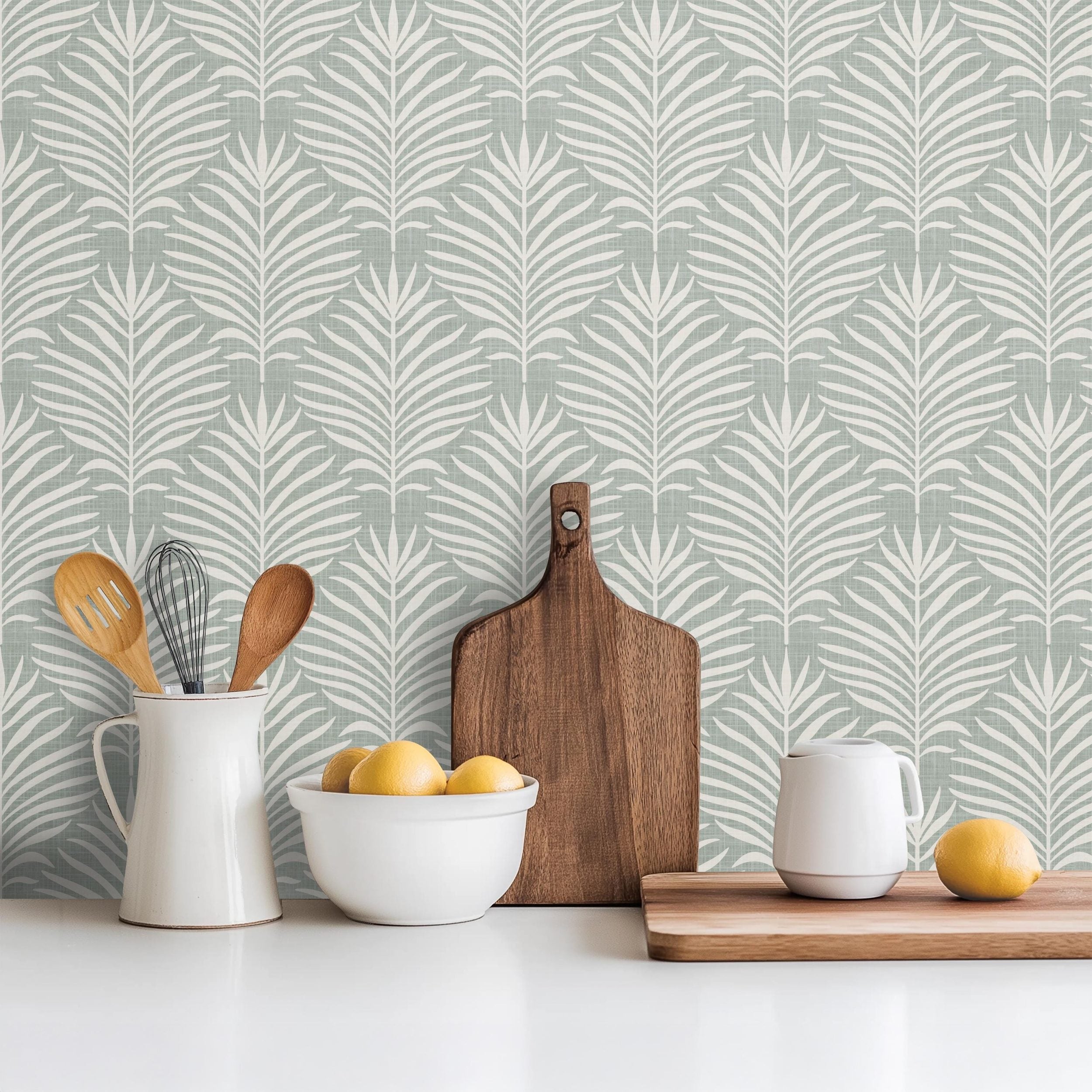 Boho Tropical Peel and Stick Wallpaper shown in peel and stick or pre-pasted. Neutral Blue Green Botanical Palm Leaf perfect for Modern Coastal interiors, baby nursery, bathroom or powder room.